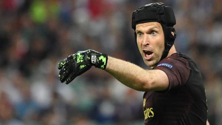 Can footballers wear a baseball cap during a match?